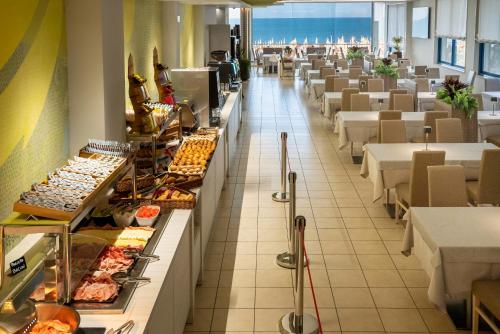 a restaurant with a buffet line of food at Hotel Marco Polo in Caorle