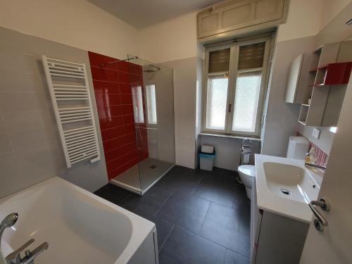 y baño con bañera, aseo y lavamanos. en Big appartement - 9 guests - Air Conditionning and Courtyard, en Bussoleno