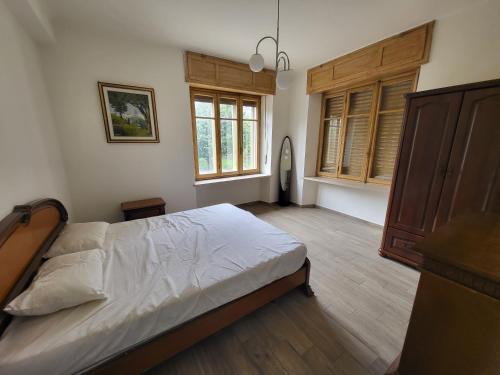 a bedroom with a bed and a large window at Big appartement - 9 guests - 30 min from ski stations in Bussoleno