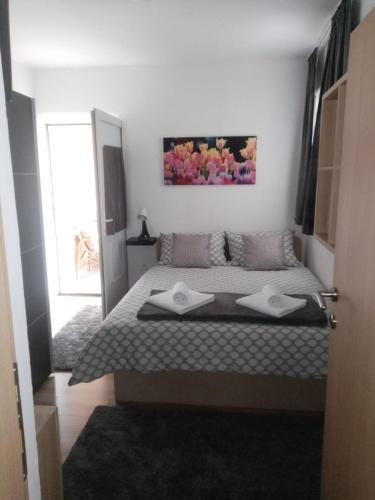 a bedroom with a bed with two towels on it at MIA in Zagreb