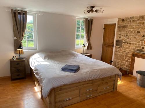 a bedroom with a large bed in a room at Gite des Trévignes in Cambremer
