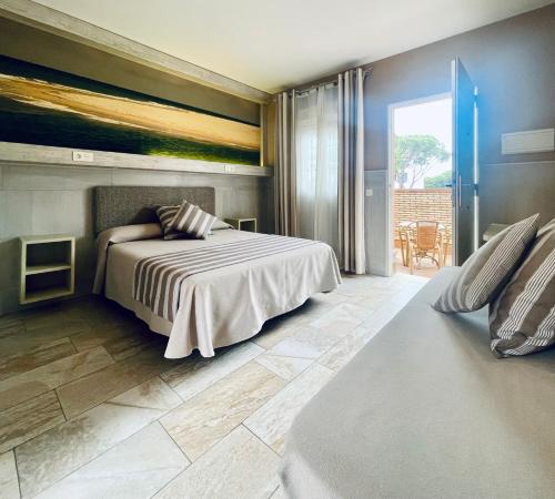 a bedroom with a bed and a large window at Hostal Noli in Chiclana de la Frontera