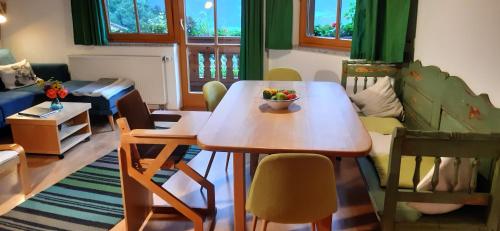 una sala de estar con una mesa con un bol de fruta. en FEWO Niederndorferberg, en Niederndorferberg