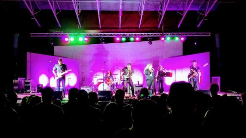 a group of musicians on a stage at a concert at Park Bungalow #4 - Seacliff Beach Suites in Leamington