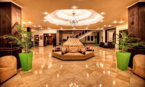 a lobby with a couch and two potted plants at Casablanca Le Lido Thalasso & Spa (ex Riad Salam) in Casablanca