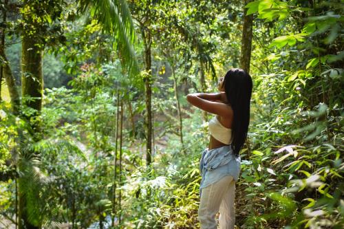 a woman walking through the forest in the jungle at BOSQUE EL DESCANSO in Jamundí