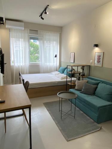 a living room with a bed and a couch at E2G URBAN STAY #G in Thessaloniki