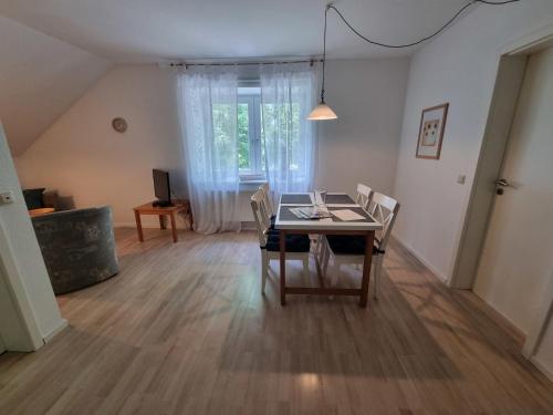 a dining room with a table and chairs at "Ferienhaus Vadersdorf" Wohnung 1 in Vadersdorf