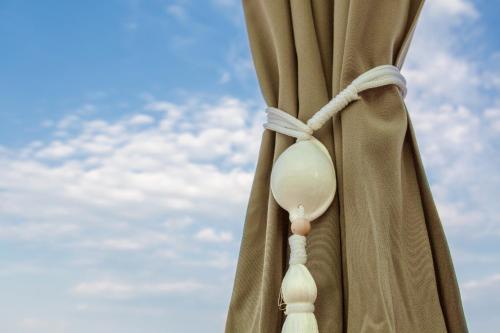 a curtain with a pacifier hanging from it at Hotel Europa Lignano in Lignano Sabbiadoro