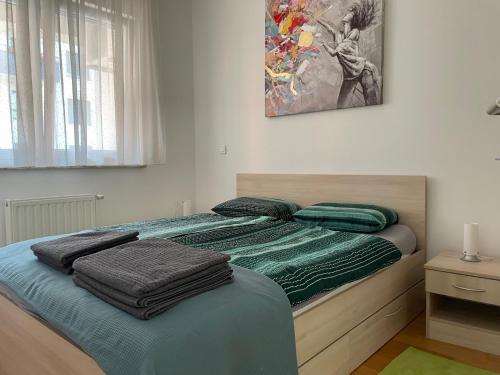 een slaapkamer met een bed met groene dekens erop bij Apartment Jelena in Zagreb