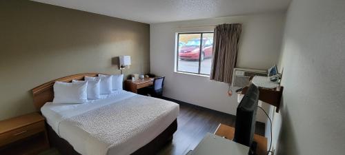 a hotel room with a bed and a window at Days Inn by Wyndham Somerset PA I-70 I-76 in Somerset