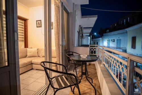 a balcony with a table and chairs and a couch at Ariadni Luxury Apartment in Samos