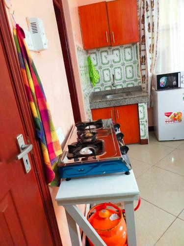 a kitchen with a stove top oven sitting on a counter at Phee home in Mombasa