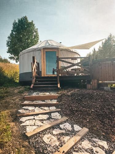a yurt with a pathway leading up to it at Jurty z widokiem, prywatna balia- DZIKOLAS GLAMPING in Krasnobród