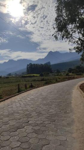 a stone road with mountains in the background at Agradável Casa de Campo, recém construída. in Divisa
