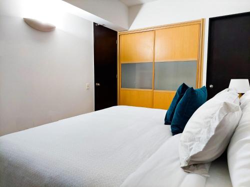 Una cama o camas en una habitación de Punto Alameda - Reforma