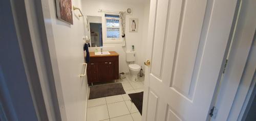 a small bathroom with a sink and a toilet at Sustainable B&B by the Bay in Brisbane