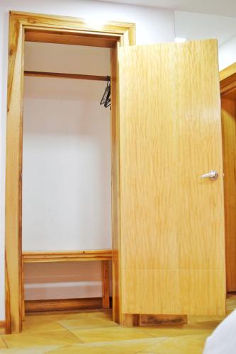ajar door of a room with a closet at Hotel Ambassador in Quito