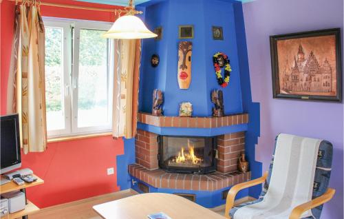 a living room with a fireplace in the corner at Cozy Home In Nowe Warpno With Wifi in Nowe Warpno