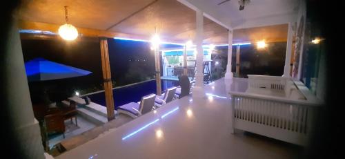 a room with a table and chairs in a house at Cantik Villa in Lovina