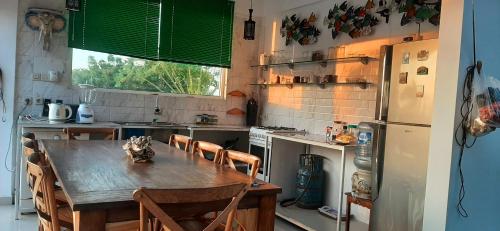 a kitchen with a table and chairs and a refrigerator at Cantik Villa in Lovina