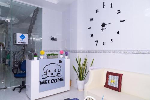 a wall clock with a teddy bear on a wall at Nina homestay P3 in Ap My Quo