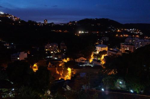 a view of a city at night with lights at Casa Caminho do Corcovado - Pet friendly in Rio de Janeiro