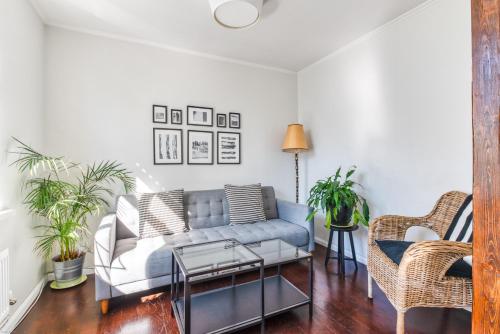 a living room with a blue couch and chairs at Sem Apartments in Reykjavík