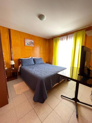 1 dormitorio con 1 cama y TV en Bahía Loreto en Caldera