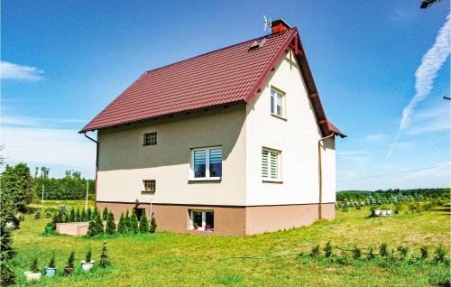 a large house on top of a green field at Beautiful Apartment In Konarzyny in Konarzyny