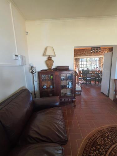 a living room with a couch and a table at Mzila Forest Creek in Maanhaarrand
