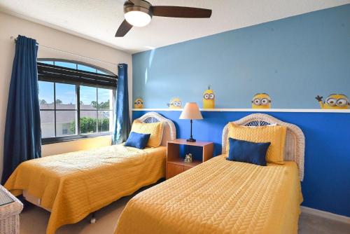 a bedroom with two beds and a blue wall at Golf getaway fun for family and friends for an Orlando theme park vacation in Davenport