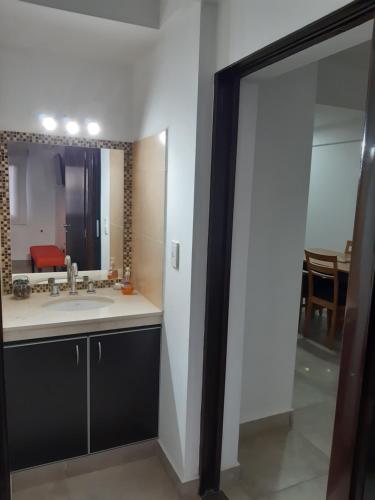 a bathroom with a sink and a mirror at Departamentos Giovanni in Salta