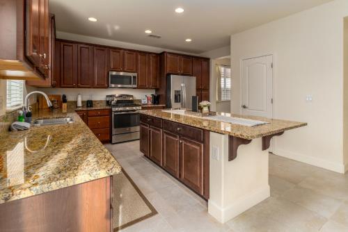 a kitchen with wooden cabinets and granite counter tops at Dream Family Home in South Reno 4 bed 30 Min to Lake Tahoe in Steamboat