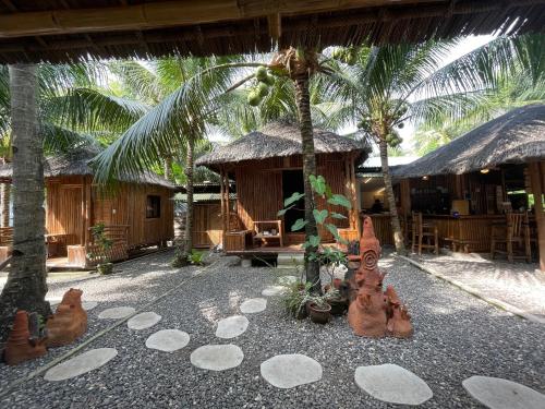 a resort with a group of sand castles on the ground at La Tortue Diving Resort Dauin in Dauin