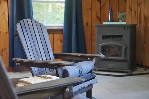 a wooden chair sitting in front of a stove at St Lawrence River Retreat in Ogdensburg