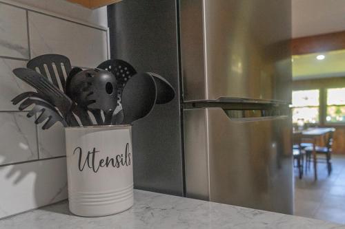a container of kitchen utensils sitting on a counter at St Lawrence River Retreat in Ogdensburg