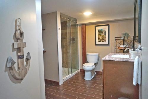 a bathroom with a shower and a toilet and a sink at St Lawrence River Retreat in Ogdensburg