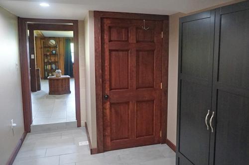 a hallway with two wooden doors and a hallway with a hallway at St Lawrence River Retreat in Ogdensburg