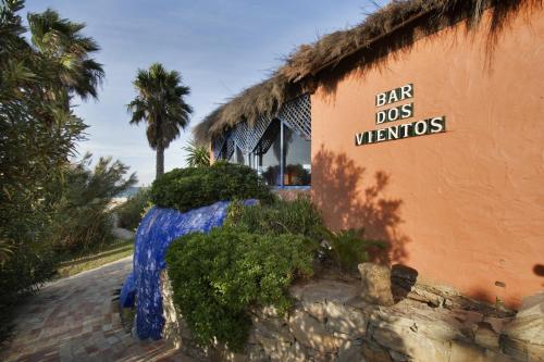 a building with a sign that reads big dogs welcome at Beach Hotel Dos Mares in Tarifa