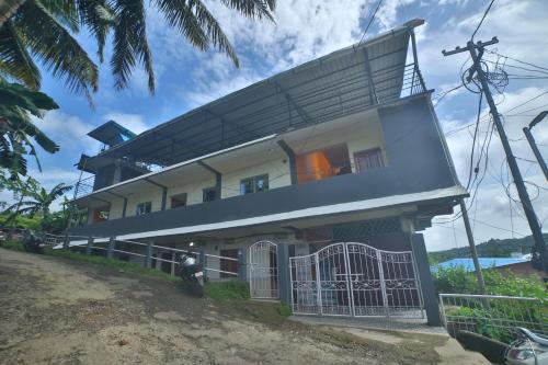 a house with a balcony on top of it at The Lagoon shade in Port Blair