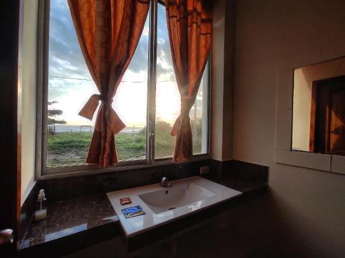 a bathroom with a sink in front of a window at Hotel California in Montañita