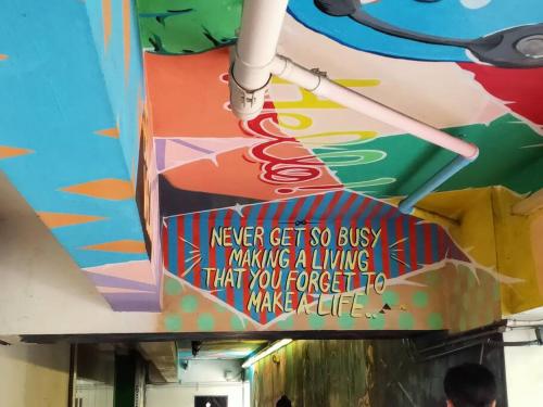 a painting on the ceiling of a building with a sign at Great View 1 BR Condo in Makati near Trident Tower in Manila