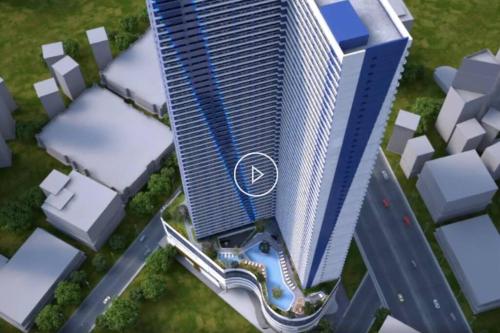 an aerial view of a tall skyscraper at Great View 1 BR Condo in Makati near Trident Tower in Manila