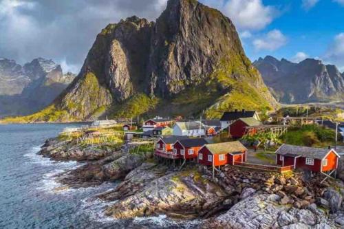 a village on the edge of the water with a mountain at Reine Front View - Mountain & Seaview in Reine