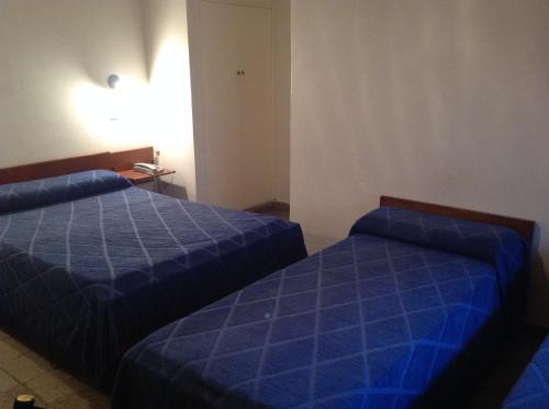 Postel nebo postele na pokoji v ubytování Hotel Mitre