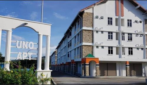 a large white building with an arch in front of it at Homestay Teratak Kasih in Sandakan