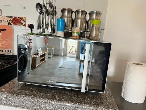 a microwave sitting on top of a kitchen counter at Kijani Paradise Malindi in Malindi