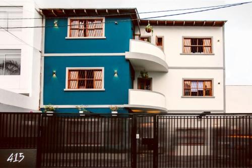 a blue and white house with a black fence at Casa Azul in Lima