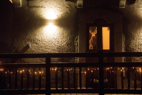 a building with a picture of a deer in a window at night at Couples Gem - Sensational views Nr Morzine in La Côte dʼArbroz